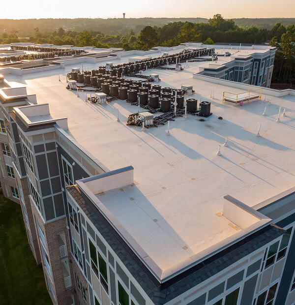Aerial view of commercial building with flat roof, HVAC units, and large-loss restoration.