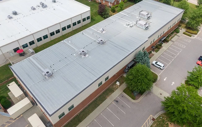 Aerial view of a flat-roof commercial building featuring commercial roofing and large-loss restoration.
