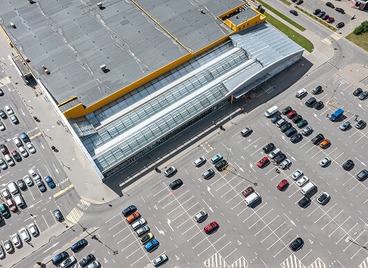 Aerial view of a commercial flat roof retail store for large-loss storm restoration.