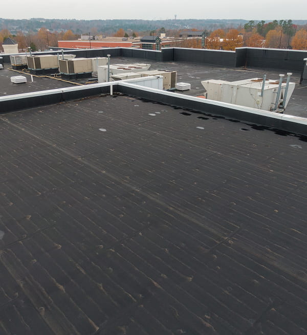 Flat commercial rooftop with HVAC units, ideal for large-loss recovery and storm damage restoration.