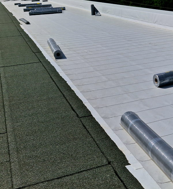 Commercial roofing materials on a flat roof for large-loss recovery and storm damage restoration.